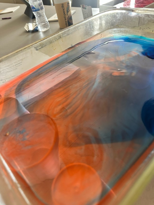 A colorful science activity in a glass dish